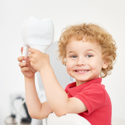 Excited boy holding a tooth