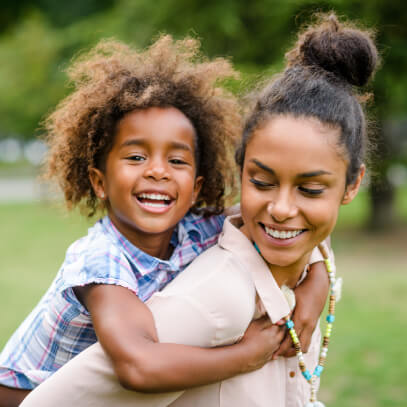 Daughter piggyback on mom