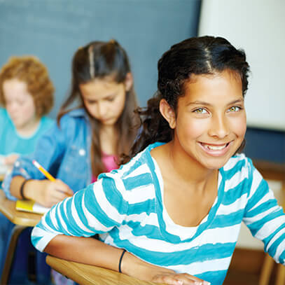 Young girl smiling in her classroom