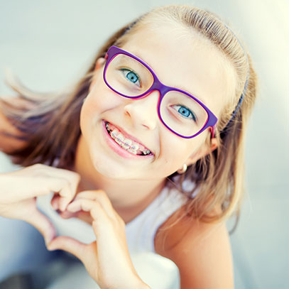 Girl with glasses and braces smiling