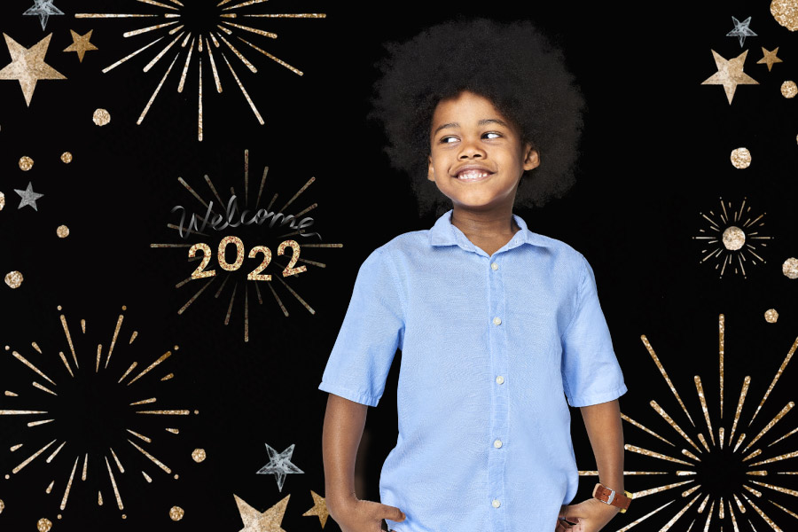 Child in a blue shirt smiles after his routine checkup to prepare for the 2022 new year