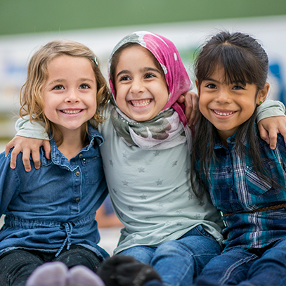 three young girls smiling