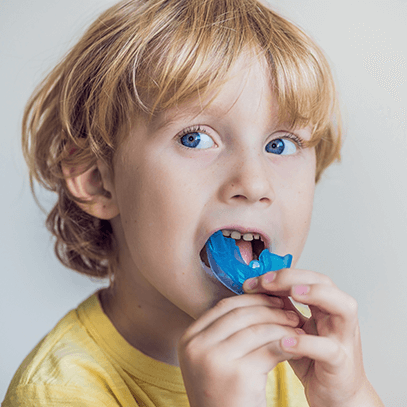 child holding a mouthguard