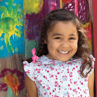 little girl smiling with white teeth