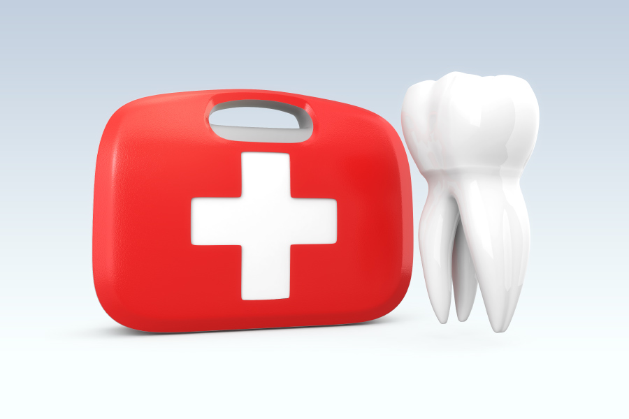 A tooth next to a red first aid kit to indicate a dental emergency