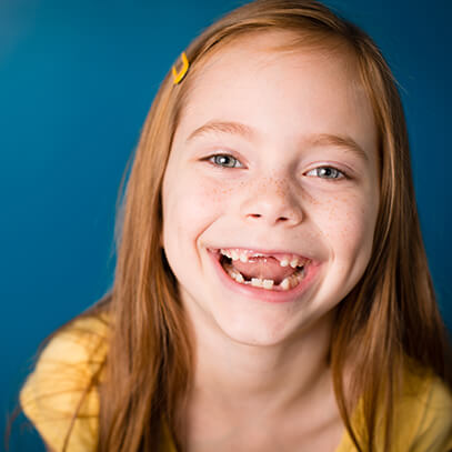 Girl with missing teeth