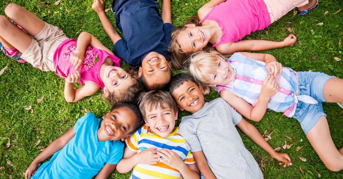kids laying on ground outside